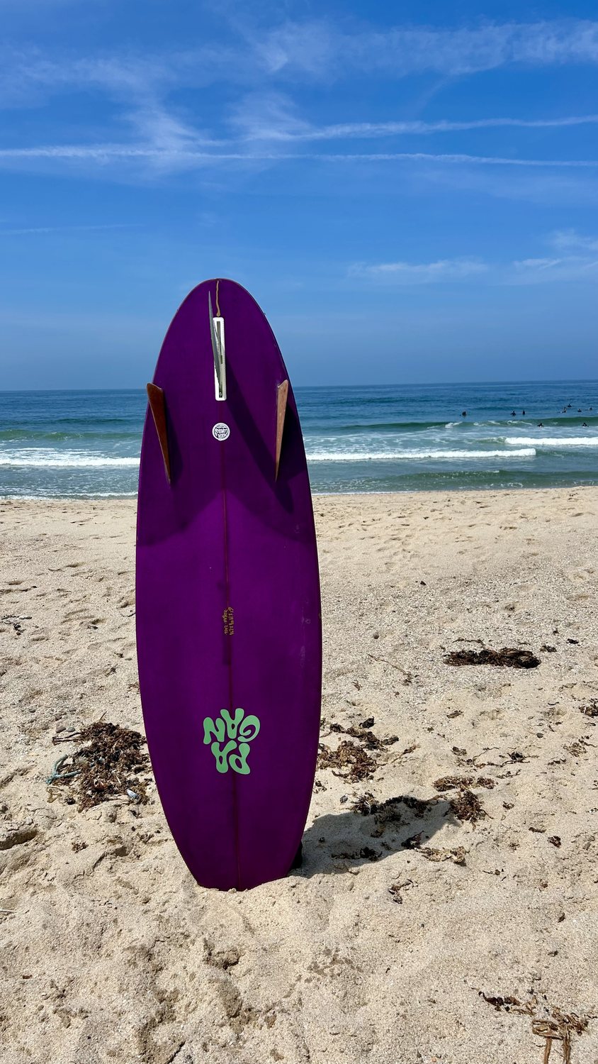 Purple board on the sand at first light