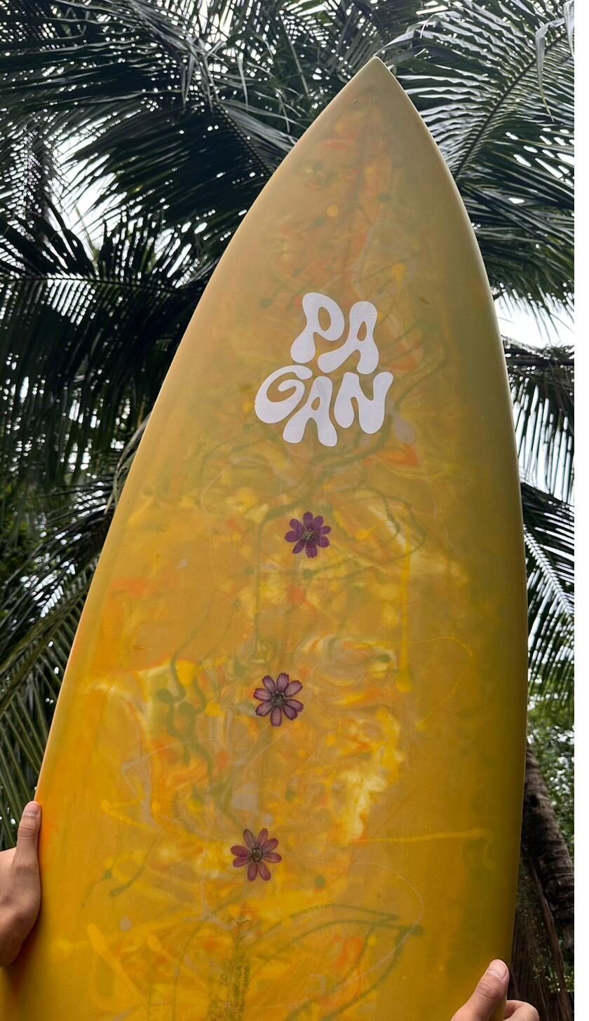 Yellow resin board with pressed flowers under the palms